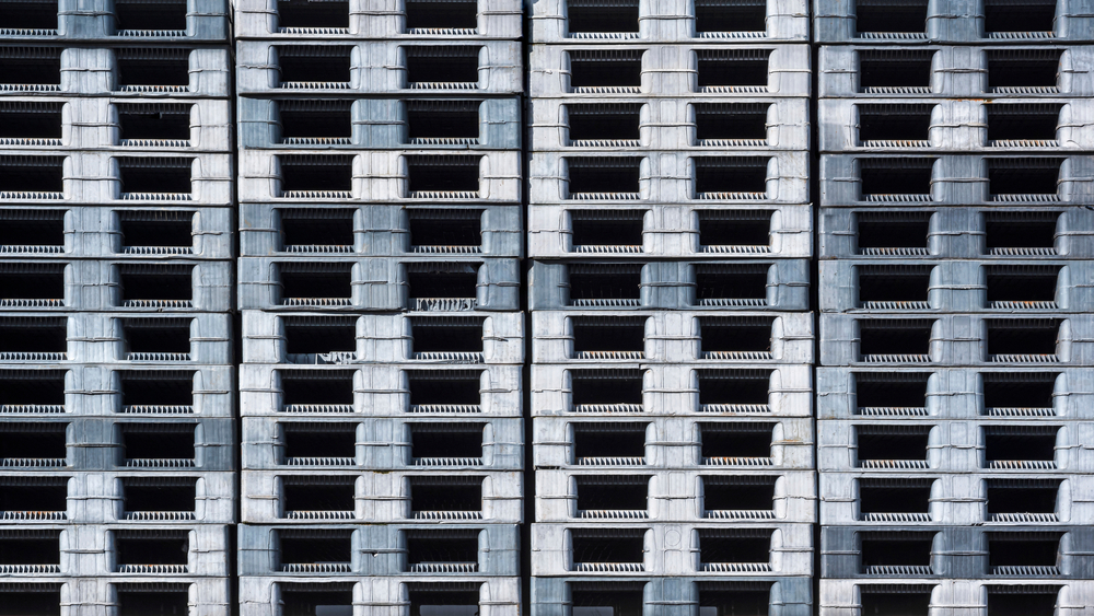 Gray plastic pallets stacked up